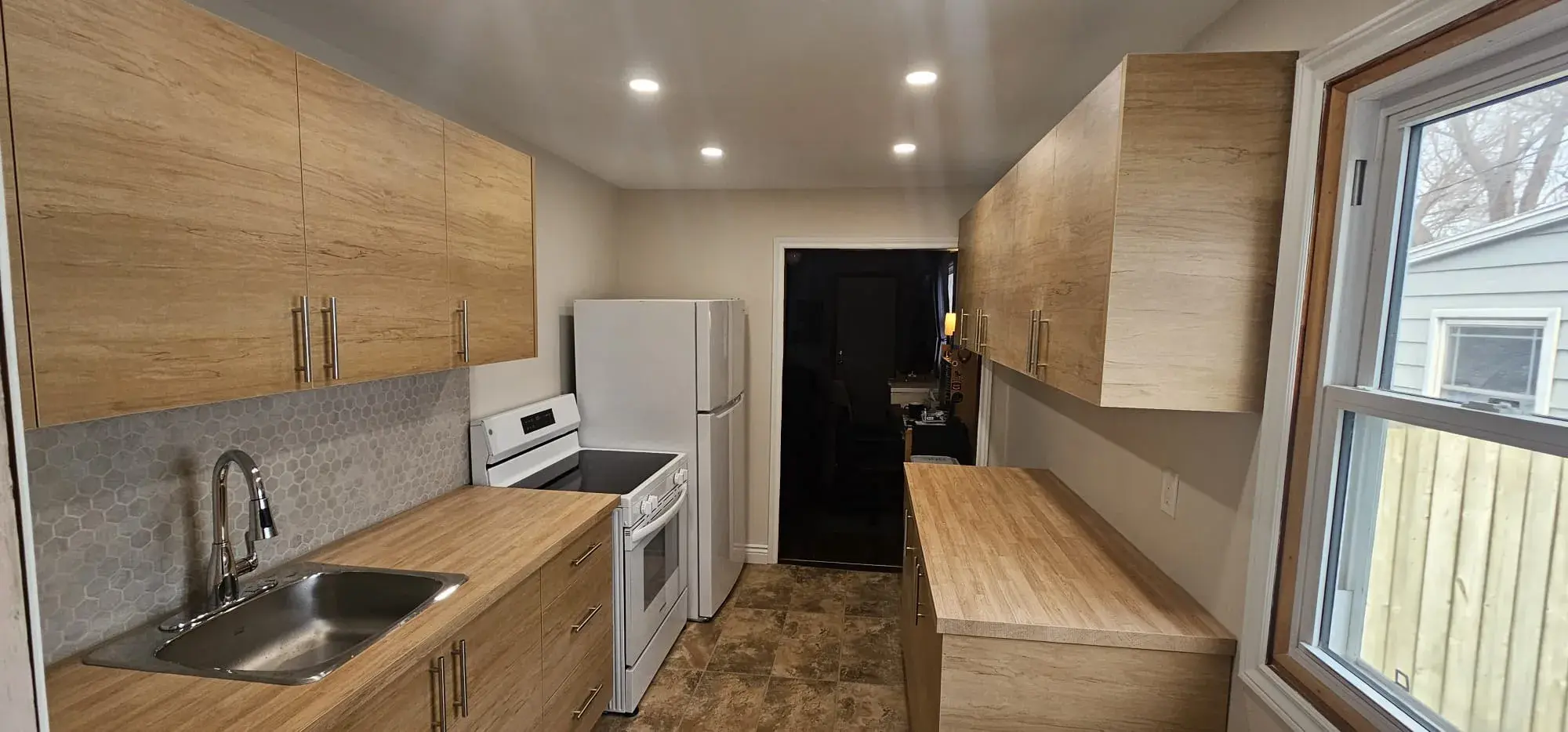 Finished kitchen remodel with updated cabinetry, counters, and lighting